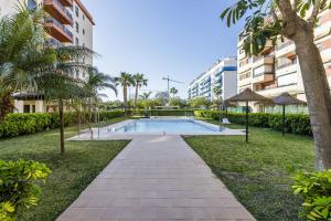 a swimming pool in a park next to a building at A&N Penthouse La Vega in Caserío Almayate Bajo