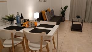 a dining room with a table and chairs with a bowl of fruit at Candelaria ocean views in Candelaria