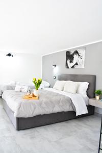 a bedroom with two large beds with white walls at B&B Peonies in Castellammare di Stabia