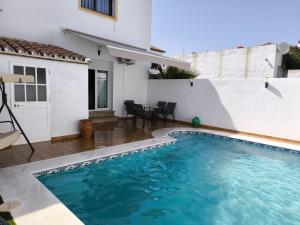 a swimming pool in the backyard of a house at Alojamiento Rural Laida in Jimena de la Frontera