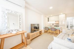 a living room with a couch and a mirror at GuestReady - Beachfront dream in Sesimbra in Sesimbra