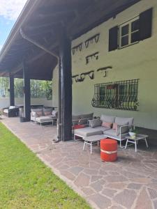 a group of couches and tables under a building at Vallarom in Avio