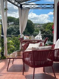 a patio with chairs and a table with a view at Quinta da Asneira in Montemor-o-Novo