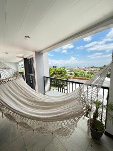 a hammock on the balcony of a house at Maria´s Apartments in Alajuela City