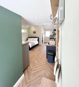 a bedroom with a bed and a desk in a room at Cedar Retreat Whitby in Whitby
