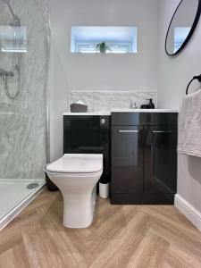 a bathroom with a toilet and a sink and a shower at Cedar Retreat Whitby in Whitby +15 photos