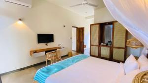 a bedroom with a bed and a desk at Oruwa Boutique Villas in Arugam Bay