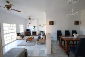 a living room with a table and a dining room at TESS Villa Ellen Maria: Space, Activity, Freedom! in Alhaurín de la Torre