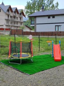 a playground with a trampoline on a green blanket at Aval-Bakuriani in Bakuriani