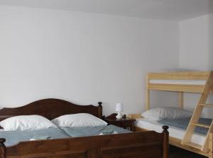a bedroom with two bunk beds and a ladder at Apartment Tela in Kobarid