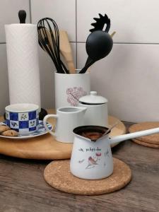 a table with cups of coffee and utensils at Apartment Tela in Kobarid