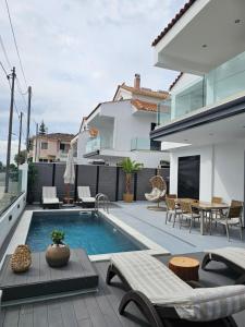 a backyard with a swimming pool and a house at Dimitra's Paradise Villa in Lygia