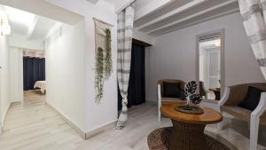 a living room with a table and chairs at POSIDONIO old town apartment in Villajoyosa