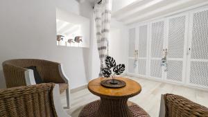 a living room with a table and two chairs at POSIDONIO old town apartment in Villajoyosa