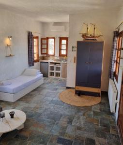 a living room with a couch and a kitchen at Fay's View Aegina in Aegina Town