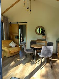 a living room with a table and chairs at Labieši in Jūrmala