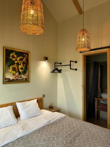 - une chambre avec un lit avec deux lampes et un tableau dans l'établissement Labieši, à Jurmala