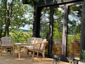 a screened in porch with chairs and a table at Labieši in Jūrmala