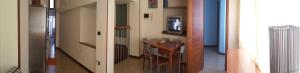 a hallway with a table and a television in a room at Rose Apartment in Crotone