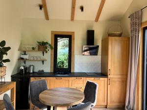 a kitchen with a wooden table and a table and chairs at Labieši in Jūrmala