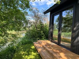 a wooden deck with a view of a river at Labieši in Jūrmala