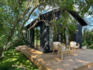 a cabin with a table and chairs on a wooden deck at Labieši in Jūrmala