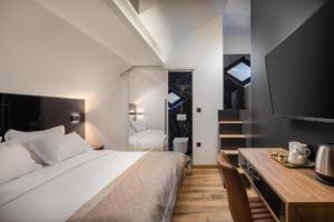a bedroom with a bed and a desk and a television at Top rooms in Split