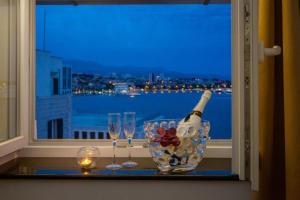 a bottle of wine and glasses on a window sill at Top rooms in Split