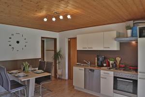 a kitchen with a table and a dining room at Apartment Alpenwelt in Neustift im Stubaital