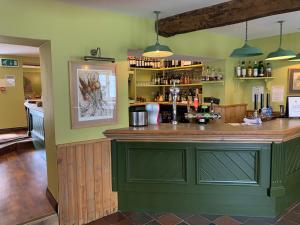 a bar with a green island in a room at The Kingsdon Inn in Kingsdon