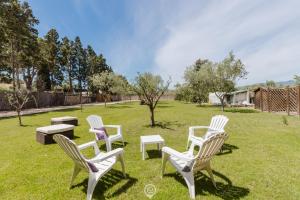 a group of chairs sitting in the grass at Villa Girasole - Calice Apartment in Pula
