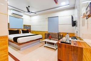 1 dormitorio con 1 cama y escritorio en una habitación en OYO Maa Bhubaneswari Hotel, en Bhubaneshwar