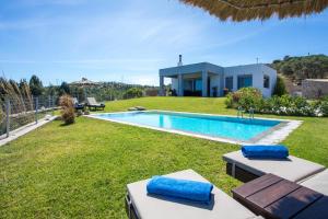 a villa with a swimming pool and a house at High View Villa in Afantou