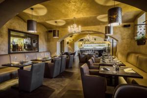 Theresian Hotel في أولوموك: مطعم بطاولات وكراسي وبار