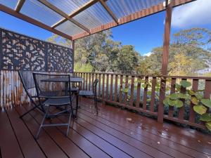 a patio with a table and chairs on a deck at Wombat Forest Country Retreat in Trentham East