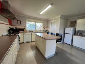 a large kitchen with white appliances and a counter top at Wombat Forest Country Retreat in Trentham East