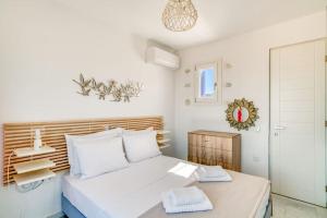 a white bedroom with a bed and a closet at Paros Sea View Eco - Aetherian Ciel Villas, Cymo in Mármara