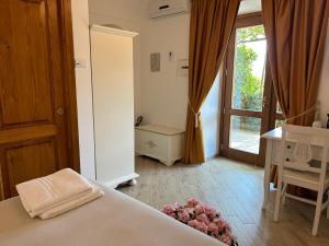 um quarto com uma cama e uma porta de vidro deslizante em Agriturismo Orrido di Pino em Agerola