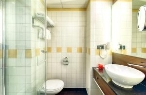 a bathroom with a sink and a toilet at Leonardo Hotel Amsterdam City Center in Amsterdam +36 photos