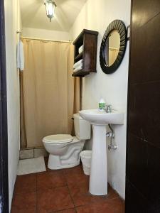 a bathroom with a toilet and a sink at Hotel Casa Nikté in Antigua Guatemala