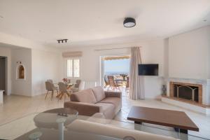a living room with a couch and a fireplace at Villa Katrin 2 in Pylos