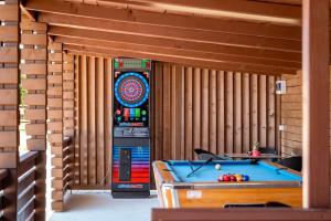a room with a pool table and a clock at Cozy and Chic Little House with Pool Ivinj-1 Vodice in Tisno