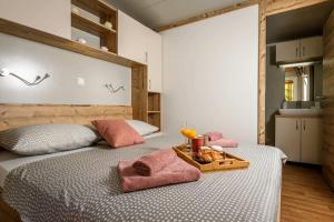 a bedroom with two beds with a tray of food on it at Cozy and Chic Little House with Pool Ivinj-1 Vodice in Tisno +52 photos