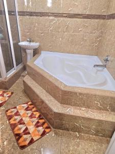 a bathroom with a bath tub and a sink at Beulah Luxury Suites in Georgetown +37 photos