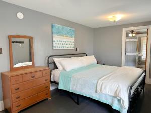 a bedroom with a bed and a dresser and a mirror at NH311B Nags Head 311B in Nags Head