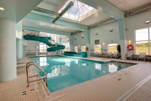 a swimming pool with a slide in a building at Hampton Inn & Suites by Hilton Dartmouth - Halifax in Halifax