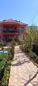 a walkway in front of a house at Vila Natasa&Sofia in 2 Mai