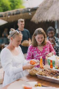 two women standing at a table preparing food at What The Duck Backpackers in Canggu