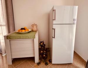 a white refrigerator in a kitchen with a bowl of fruit at Domus Angela in Polignano a Mare