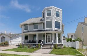 a gray house with a white porch and stairs at 309 E Jefferson Ave in Wildwood Crest
